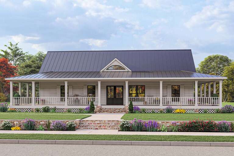 A white ranch-style house with a wraparound porch, and a two-car garage.
