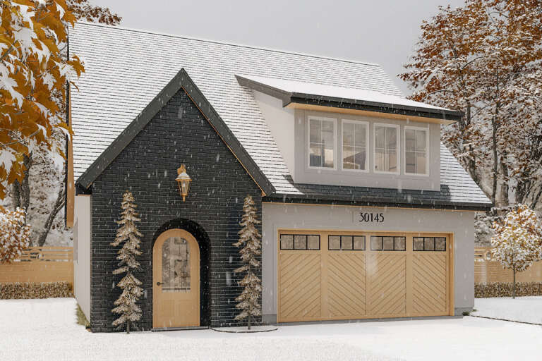 A black and white brick 800 sq ft house with gold trim and accents in the winter.