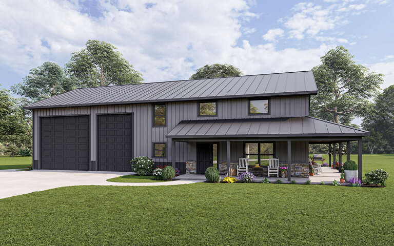 What is a barndominium? This is a light gray barndominium with dark gray trim and garage bay doors.