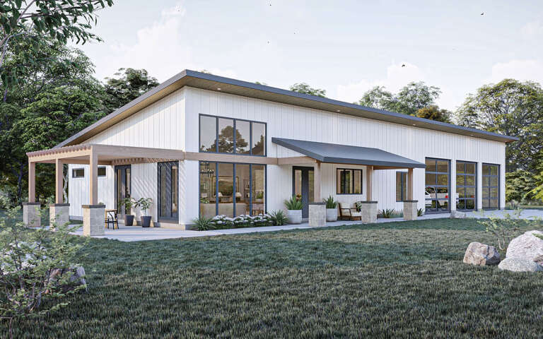 What is a barndominium? This is a modern white barndominiums with gray trim and large windows.