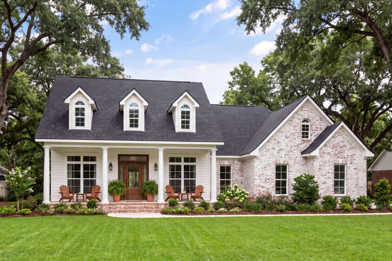 White Country, Angled Front Elevation, brick and siding, dormers, porch columns, wooden door, lanterns, lush landscaping. House Plan # 041-00010 Digital Rendering by America's Best House Plans, Inc.