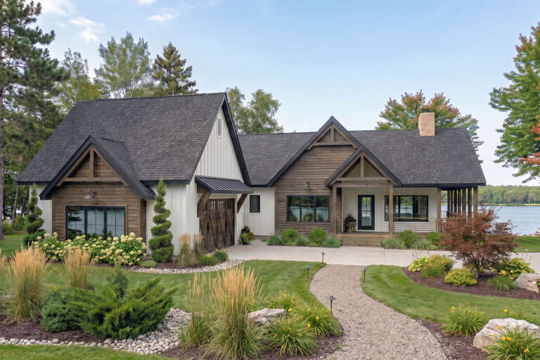 Brown and white Modern Farmhouse, Front Elevation, wood and board-and-batten siding, stone chimney, gravel path, garden. House Plan # 963-00563 Digital Rendering by America's Best House Plans, Inc.