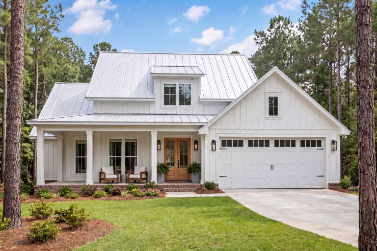 Front view of a white house in Modern Farmhouse style, metal roof, board-and-batten siding, wood door, and front porch. House Plan # 041-00266