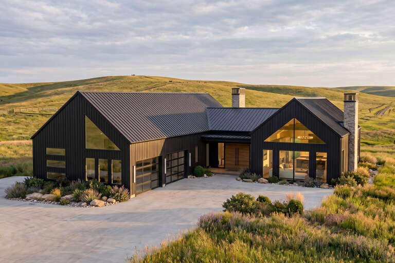 Black Modern Transitional, Angled Front Elevation, metal siding, stone chimneys, glass garage doors, and native landscape. House Plan # 963-01087 Digital Rendering by America's Best House Plans, Inc.