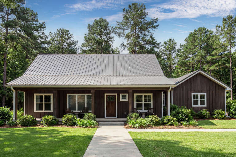 Front view of a brown house in Modern Farmhouse style, metal roof, board-and-batten siding, and covered front porch. House Plan # 3125-00040