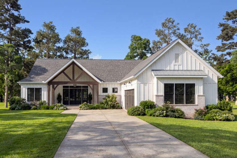 White Modern Farmhouse, Front Elevation, board-and-batten siding, brick accents, timber porch, concrete drive, lush lawn. House Plan # 009-00527 Digital Rendering by America's Best House Plans, Inc.