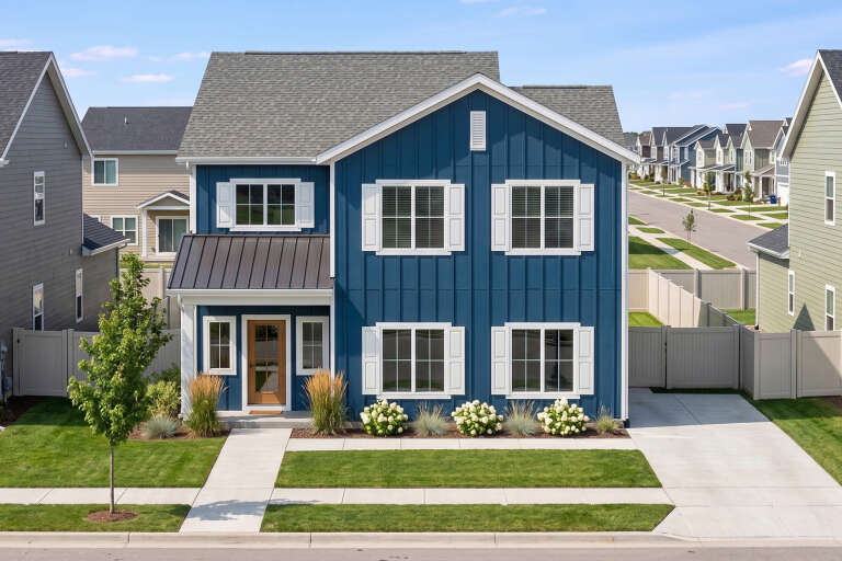 Blue Modern Farmhouse, Front Elevation, board-and-batten siding, white shutters, metal roof accent, wood door, landscaping. House Plan # 963-01313 Digital Rendering by America's Best House Plans, Inc.