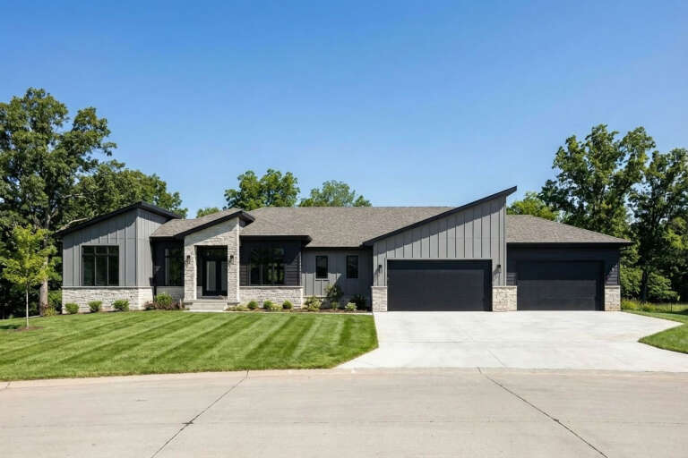 Grey Modern Transitional, Front Elevation with board-and-batten siding, stone veneer, black garage doors, and lawn. House Plan # 402-01916 Digital Rendering by America's Best House Plans, Inc.
