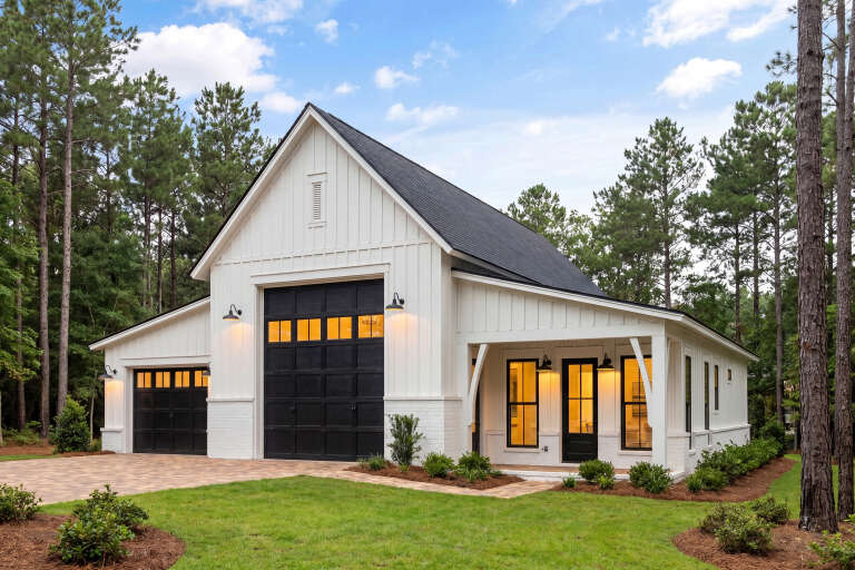 White Modern Farmhouse, Angled Front Elevation, board-and-batten siding, brick base, black garage doors, gooseneck lights. House Plan # 041-00450 Digital Rendering by America's Best House Plans, Inc.