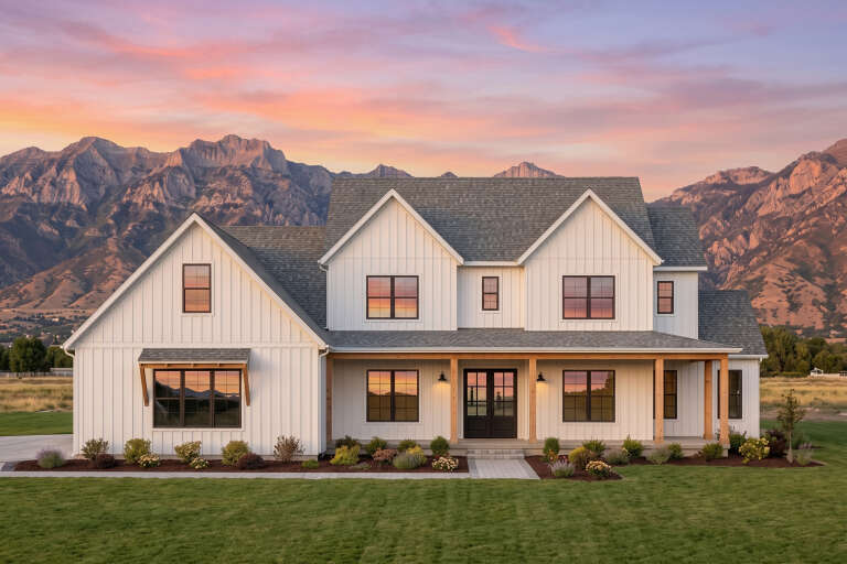 White Modern Farmhouse, Front Elevation at sunset, board-and-batten siding, wood porch posts, lit sconces, mountain view. House Plan # 7983-00204 Digital Rendering by America's Best House Plans, Inc.