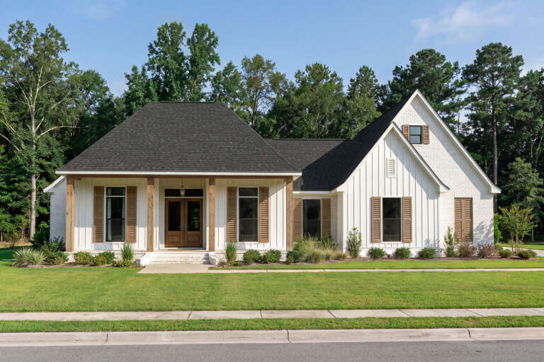 White Modern Farmhouse, Angled Front Elevation, board-and-batten siding, brick accents, wood shutters, porch, landscaping. House Plan # 2473-00016 Digital Rendering by America's Best House Plans, Inc.