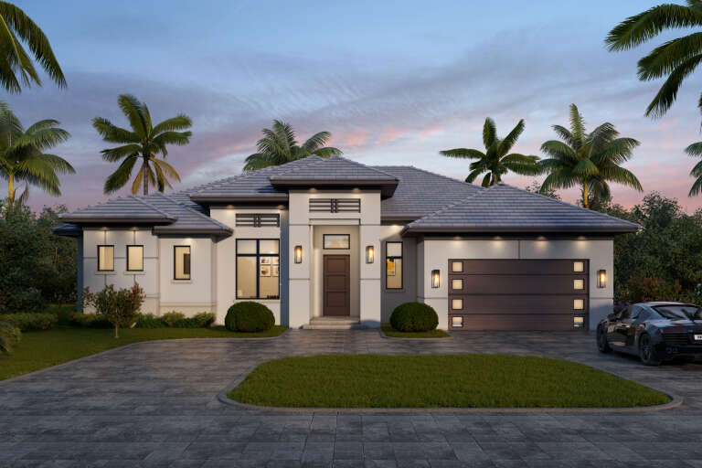 White Modern, Front Elevation at dusk, stucco siding, tiled roof, wood garage door, palm trees, and warm wall lighting. House Plan # 5565-00187 Digital Rendering by America's Best House Plans, Inc.