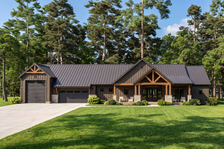 Front view of a brown Barndominium house, metal roof, stone accents, timber trusses, and covered porch. House Plan # 009-00534