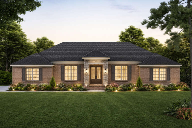 Red brick Traditional, Front Elevation with stone entry, dark shutters, lit windows, porch lanterns, and lush landscaping. House Plan # 940-01478 Digital Rendering by America's Best House Plans, Inc.