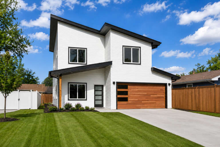 White Modern, Angled Front Elevation, horizontal siding, wood garage door, concrete driveway, and manicured lawn. House Plan # 402-01928 Digital Rendering by America's Best House Plans, Inc.