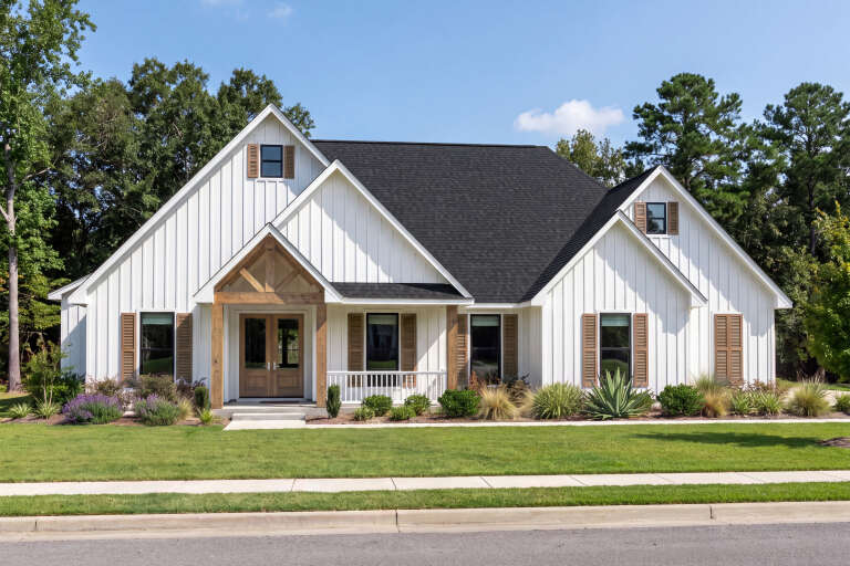White Modern Farmhouse, Front Elevation, vertical siding, timber porch, brown shutters, lush landscaping, green lawn. House Plan # 2473-00017 Digital Rendering by America's Best House Plans, Inc.
