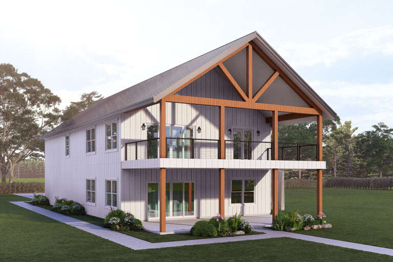 White Barndominium, Angled Front Elevation, board-and-batten siding, timber frame porch, balcony, and lush landscaping. House Plan # 3822-00036 Digital Rendering by America's Best House Plans, Inc.