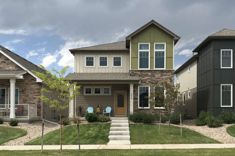 Tan Contemporary Front Elevation, stone and lap siding, green board-and-batten gable, concrete steps, and front lawn. House Plan # 5631-00353 Digital Rendering by America's Best House Plans, Inc.