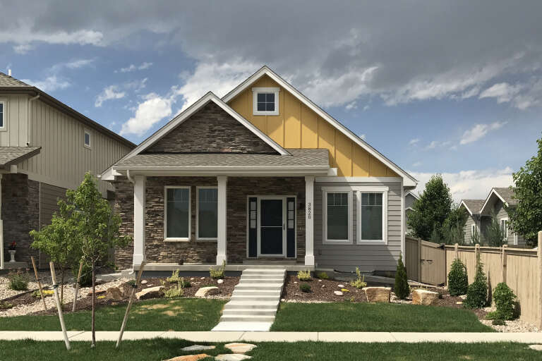 Yellow Craftsman, Front Elevation with stone veneer, board-and-batten siding, white columns, concrete steps, landscaping. House Plan # 5631-00356 Digital Rendering by America's Best House Plans, Inc.