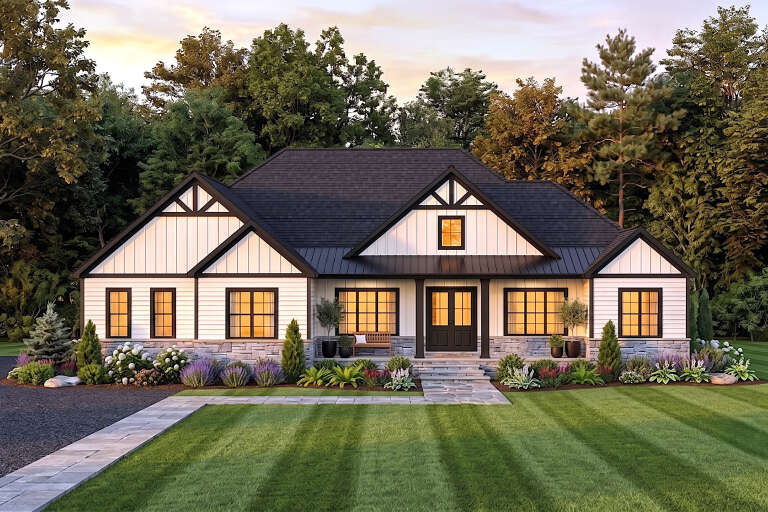 White Craftsman, Front Elevation with board-and-batten siding, stone base, dark roof, lit windows, and lush landscaping. House Plan # 1958-00080 Digital Rendering by America's Best House Plans, Inc.