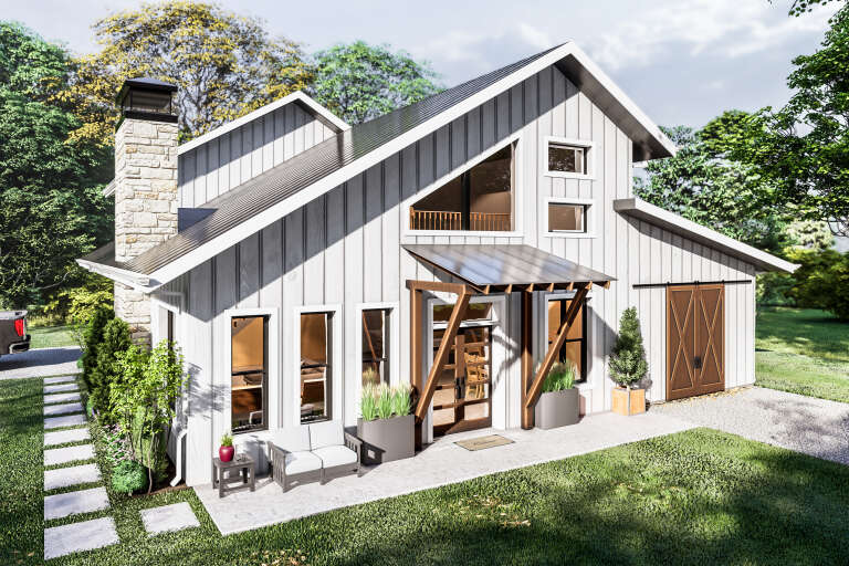 Angled front view of a white house in Modern Farmhouse style, stone chimney, metal roof, and wood-accented entryway. House Plan # 3822-00051