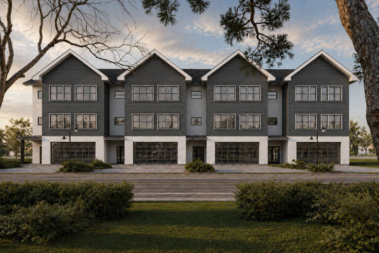 Front view of a gray and white house in Contemporary style, gabled rooflines, large windows, and ground-level garages. House Plan # 4100-00060