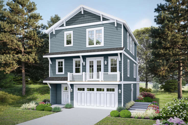 Angled front view of a blue house in Coastal style, white trim, balcony, garage, and lush landscaping. House Plan # 940-01494