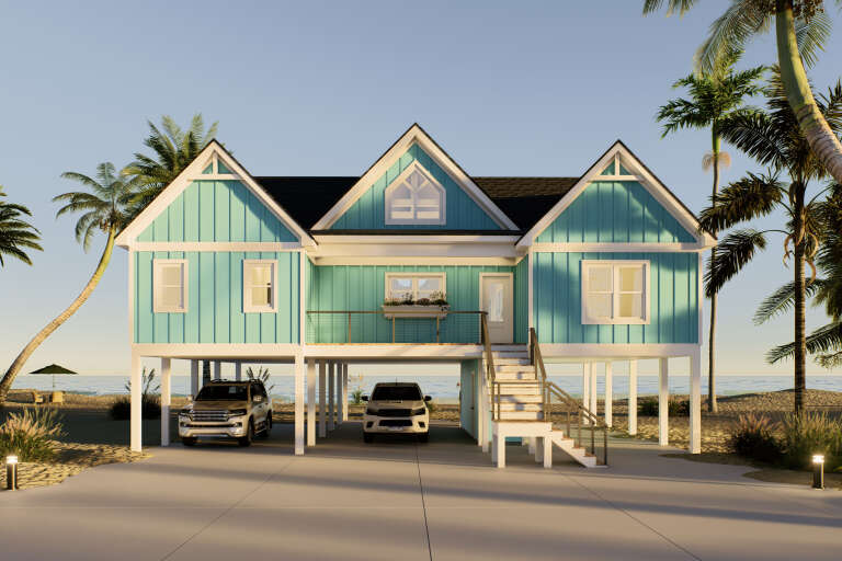 Front view of a blue house, stilt foundation, triple gables, beach setting, elevated deck, and staircase. House Plan # 940-01497