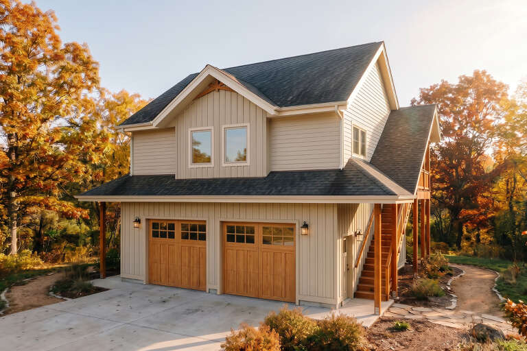 Angled front view of a beige house in Modern Farmhouse style, wood garage doors, exterior staircase, and gabled roof. House Plan # 5460-00024