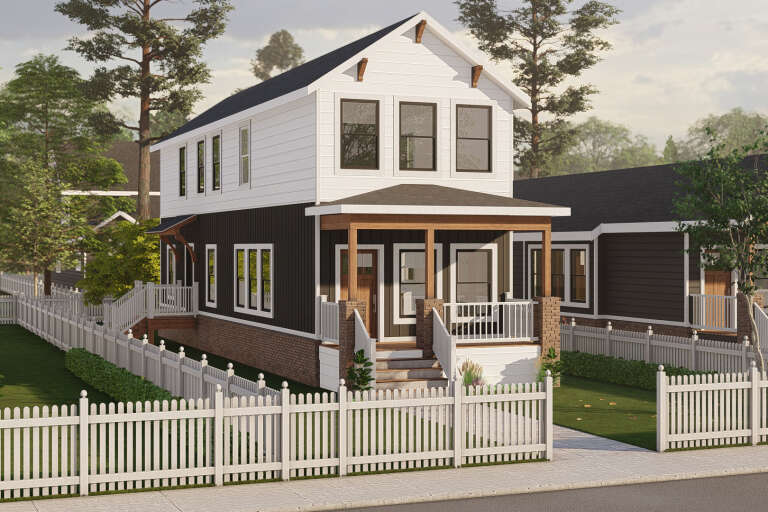 Angled front view of a white and black Traditional house, brick base, wood porch, gabled roof, and white picket fence. House Plan # 3822-00066