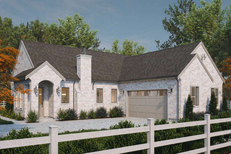 Angled front view of a white stone European house, gabled roof, stone chimney, arched entry, and attached garage. House Plan # 2452-00024