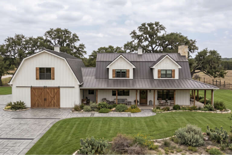 Front view of a white house in Barndominium style, metal roof, wood accents, dormers, and a spacious covered porch. House Plan # 963-01347