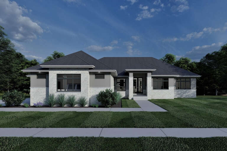 Front view of a white and gray house, stone and stucco siding, hip roof, dark windows, and landscaped front lawn. House Plan # 7140-00048