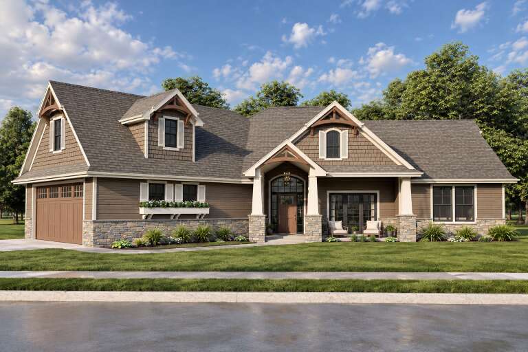 Front view of a brown house in Craftsman style, stone base, shake siding, gabled roof, and covered porch with columns. House Plan # 7140-00051