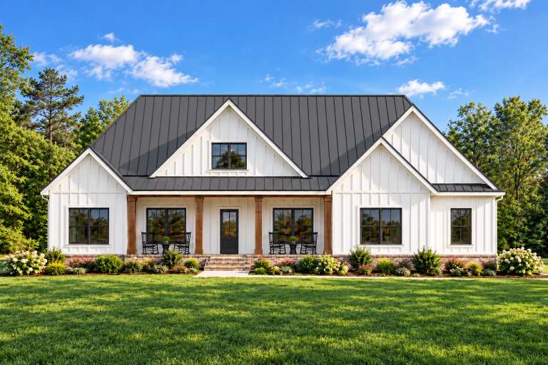 Front view of a white house in Modern Farmhouse style, metal roof, black windows, wood columns, and covered porch. House Plan # 7568-00069