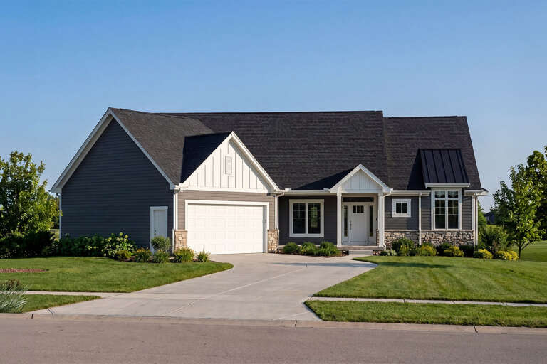 Front view of a gray Craftsman house, white board-and-batten accents, stone base, dark roof, and two-car garage. House Plan # 402-01941