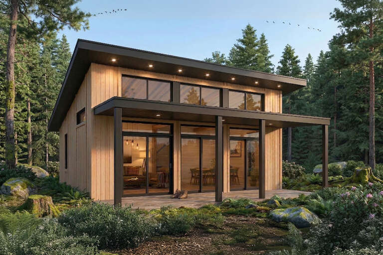 Angled front view of a natural wood house in Modern style, shed roof, black trim, large glass doors, and forest setting. House Plan # 034-01455